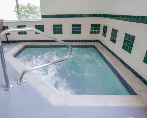 a hot tub with a hand rail in a building at Comfort Inn & Suites Moberly in Moberly