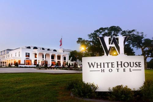 a white house with a sign in front of it at White House Hotel in Biloxi
