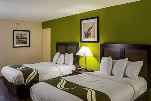 A bed or beds in a room at Quality Inn Biloxi Beach