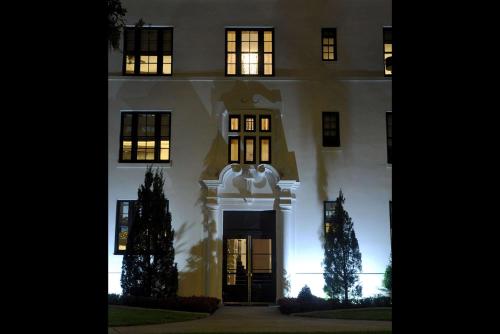 a white building with a christmas tree in front of it at White House Hotel in Biloxi