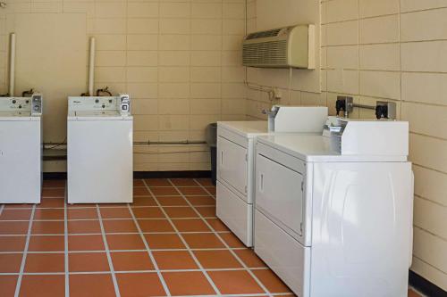 
a kitchen with a white refrigerator and a white sink at Quality Inn Biloxi Beach in Biloxi
