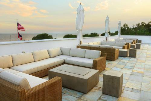 a group of couches and umbrellas on a patio at White House Hotel in Biloxi