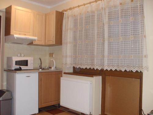 a kitchen with a sink and a microwave at Apartmany Danka in Pavčina Lehota