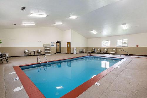 a pool in a large room with chairs and tables at Econo Lodge Livingston Gateway to Yellowstone in Livingston