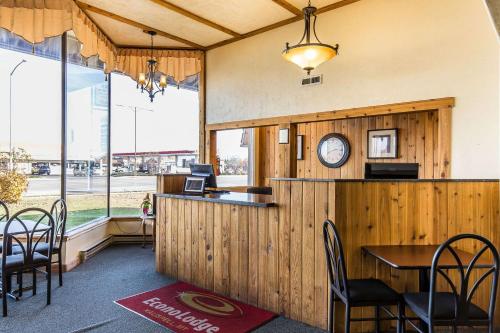 a restaurant with a counter with chairs and a clock at Econo Lodge Inn & Suites Kalispell in Kalispell