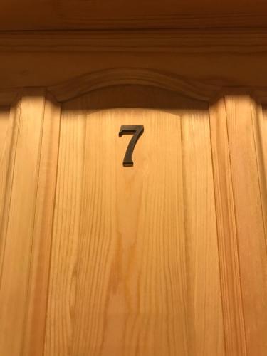 a wooden door with the number seven on it at Osada Groń in Groń