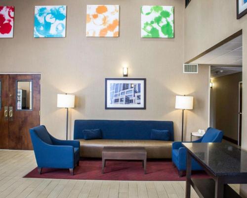 a living room with a blue couch and blue chairs at Comfort Inn & Suites Fuquay Varina in Fuquay-Varina