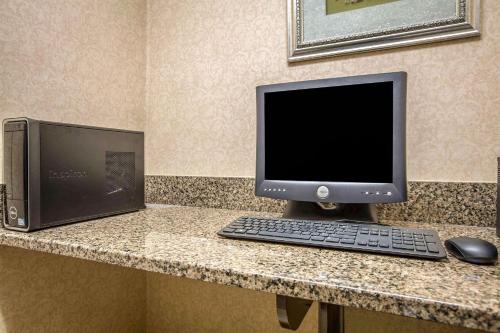 a computer monitor and a keyboard and mouse on a counter at Quality Inn Franklin in Franklin