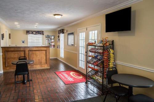 a room with a counter and a table and chairs at Econo Lodge Crystal Coast in Morehead City