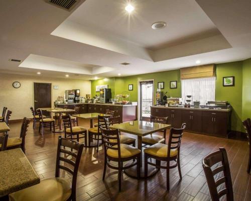 a restaurant with tables and chairs and a kitchen at Sleep Inn Asheville-Biltmore West in Asheville