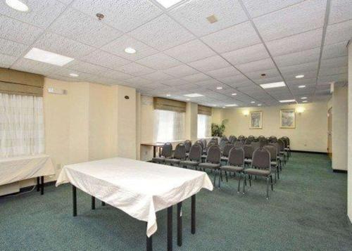 a conference room with a table and chairs in it at Sleep Inn Garner - Clayton in Garner