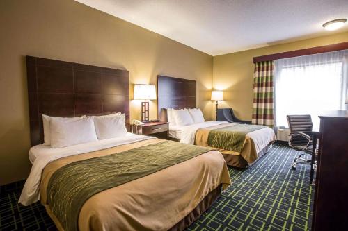 a hotel room with two beds and a window at Quality Inn Franklin in Franklin