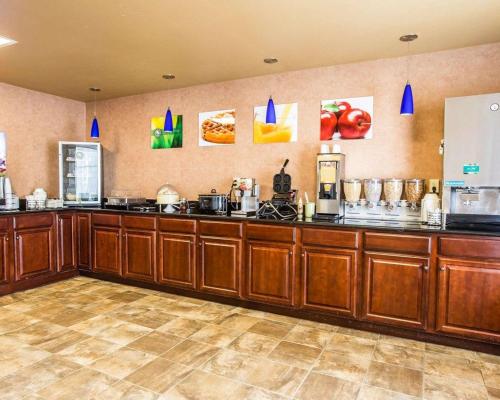 a large kitchen with wooden cabinets and appliances at Quality Inn & Suites - Greensboro-High Point in Greensboro