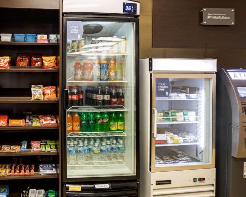 an open refrigerator in a store with drinks at Charlotte Suites by IHG in Charlotte