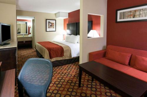 a hotel room with a bed and a couch at Comfort Inn & Suites Statesville - Mooresville in Statesville