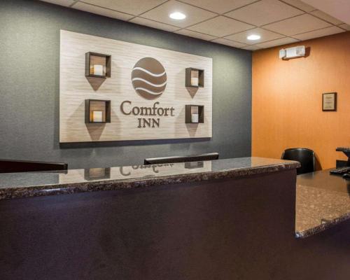 a lobby with a confident inn sign on the wall at Comfort Inn & Suites Lumberton Central I-95 in Lumberton