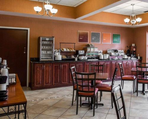 a restaurant with a table and chairs and a counter at Comfort Inn & Suites Lumberton Central I-95 in Lumberton