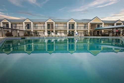 a large swimming pool in front of a hotel at Quality Inn & Suites Hanes Mall in Winston-Salem