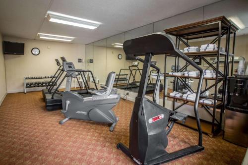 a gym with two exercise bikes and a treadmill at Quality Inn & Suites Hanes Mall in Winston-Salem