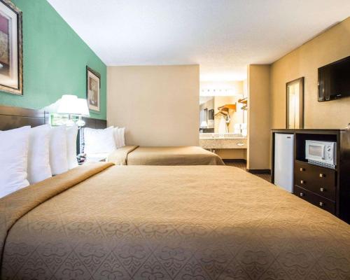 a hotel room with two beds and a television at Quality Inn Andrews in Andrews