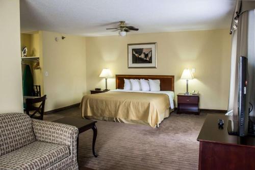 a hotel room with a bed and a couch at Quality Inn Fuquay Varina East in Fuquay-Varina