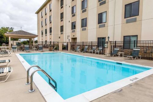 a swimming pool at a hotel with chairs and a building at Sleep Inn & Suites Mount Olive North in Mount Olive