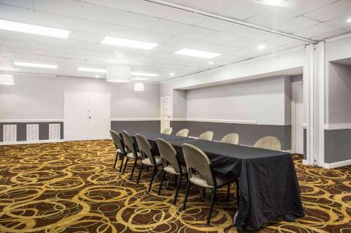 a conference room with a table and chairs on a carpet at Quality Inn & Suites University Area in Charlotte