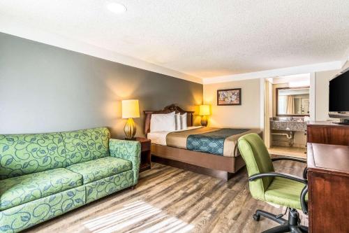 a hotel room with a couch and a bed at Econo Lodge - Gastonia in Gastonia