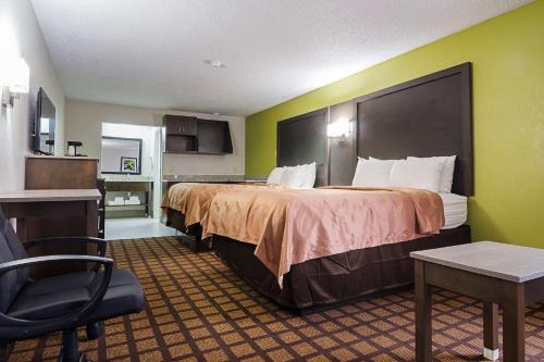a hotel room with two beds and a kitchen at Quality Inn Raeford in Raeford