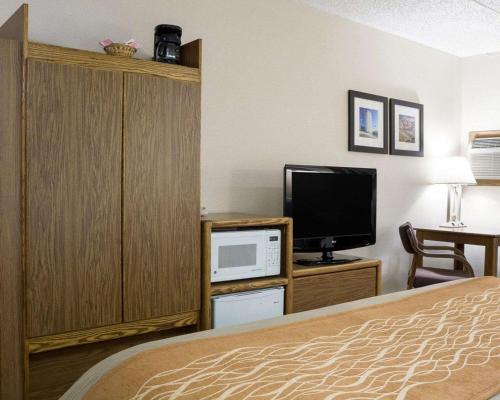 a hotel room with a bed and a tv at Quality Inn Bismarck I-94 in Bismarck
