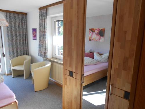 a small bedroom with a bed and a window at Ferienwohnung Schreieck Maria in Hofen
