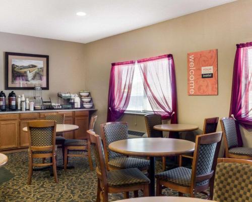 a restaurant with tables and chairs and a counter at Comfort Inn Jamestown South in Jamestown