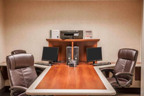 a conference room with a table with chairs and a printer at Sleep Inn & Suites Conference Center and Water Park in Minot