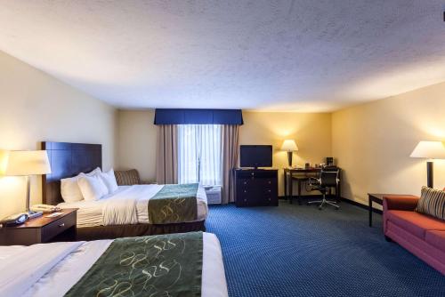 a hotel room with two beds and a desk at Comfort Suites East Lincoln - Mall Area in Lincoln