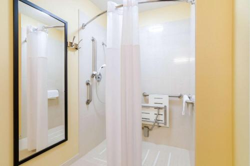 a bathroom with a shower and a mirror at Quality Inn & Suites in Ogallala