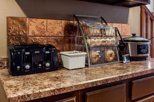 a kitchen counter with a counter top with a toaster and food at Rodeway Inn in Holdrege