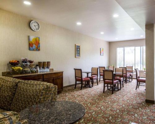 a waiting room with chairs and a clock on the wall at Econo Lodge Lakes Region in West Ossipee