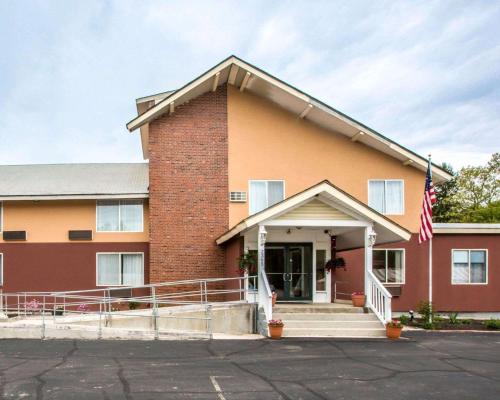 a building with an american flag in front of it at Econo Lodge Lakes Region in West Ossipee