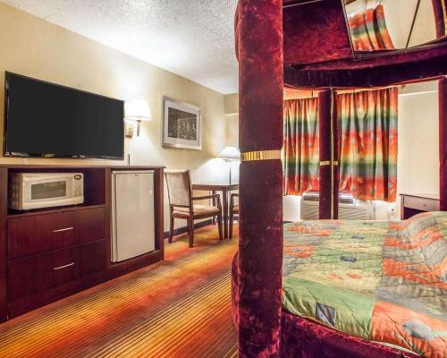 a hotel room with a bunk bed and a flat screen tv at Days Inn by Wyndham Jersey City in Jersey City