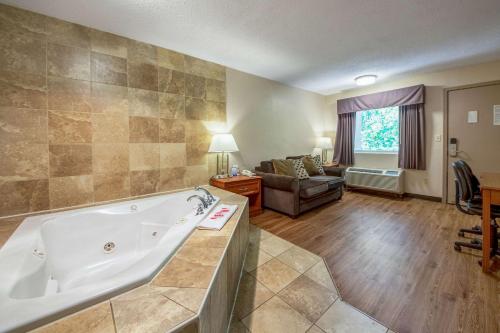 a large bathroom with a tub and a living room at Econo Lodge in Mount Laurel