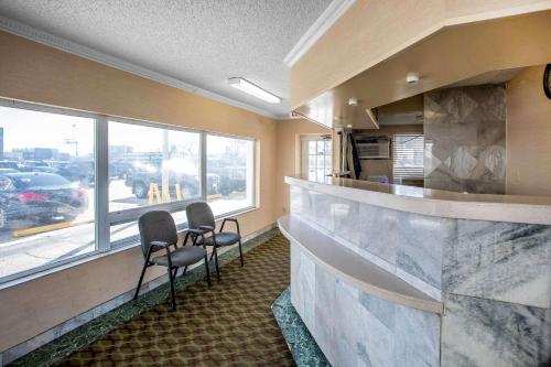 a bar with two chairs in a room with a window at The Boards AC in Atlantic City