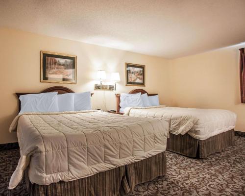 a hotel room with two beds and two lamps at Econo Lodge in Newton
