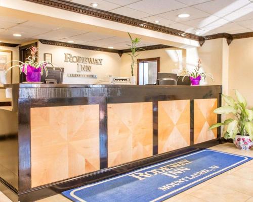 a lobby with a reception desk with plants at Rodeway Inn Mount Laurel Hwy 73 in Mount Laurel