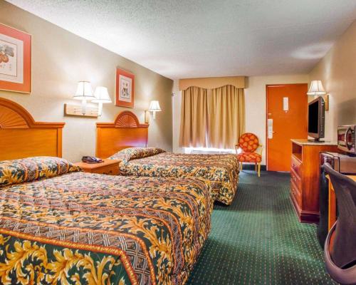 a hotel room with two beds and a television at Rodeway Inn Mount Laurel Hwy 73 in Mount Laurel