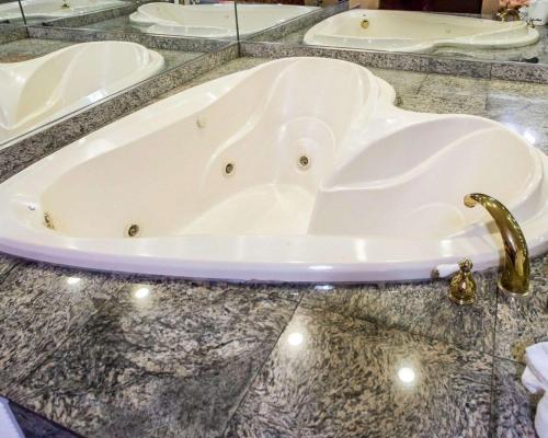 a bath tub on a marble counter with a faucet at Rodeway Inn in Jersey City