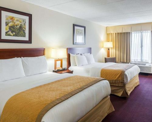 a hotel room with two beds and a window at Clarion Hotel Somerset - New Brunswick in Somerset