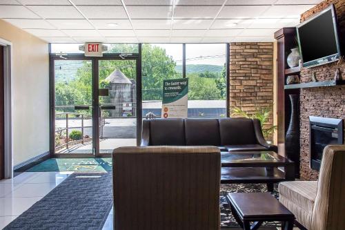 a waiting room with a couch and a fireplace at Quality Inn near Mountain Creek in Vernon