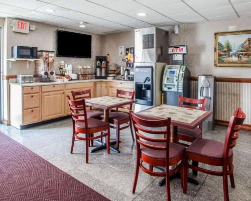 a kitchen with a table and chairs and a refrigerator at Rodeway Inn in Jersey City