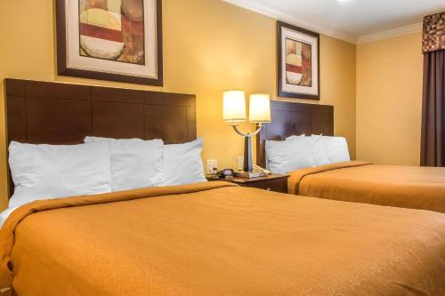 a hotel room with two beds and two lamps at Quality Inn near Mountain Creek in Vernon