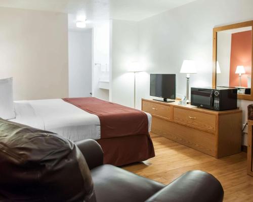 a hotel room with a bed and a television at Econo Lodge Albuquerque Old Town in Albuquerque